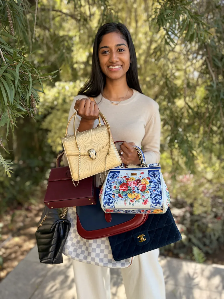 A member holding a selection of authenticated designer bags