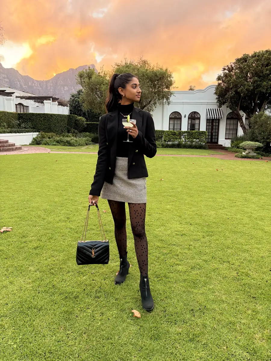 A member carrying a designer bag at an event at sunset