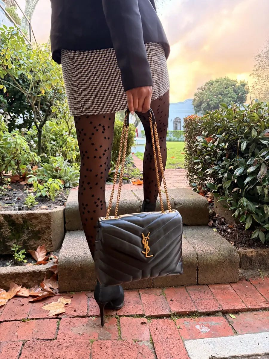 A member carrying an authenticated Saint Laurent bag